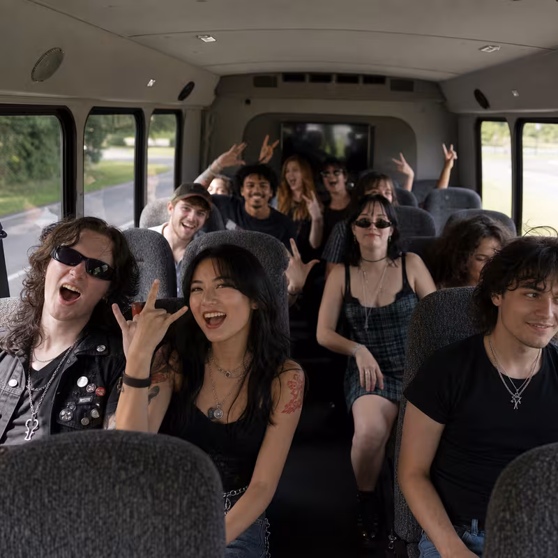 Party bus interior with wraparound leather seating and LED lighting in Aurora