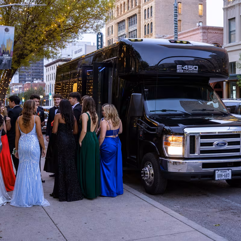 Passengers loading luggage while boarding an Aurora group shuttle