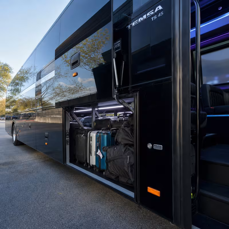 Party bus interior with wraparound leather seating and LED lighting in Aurora