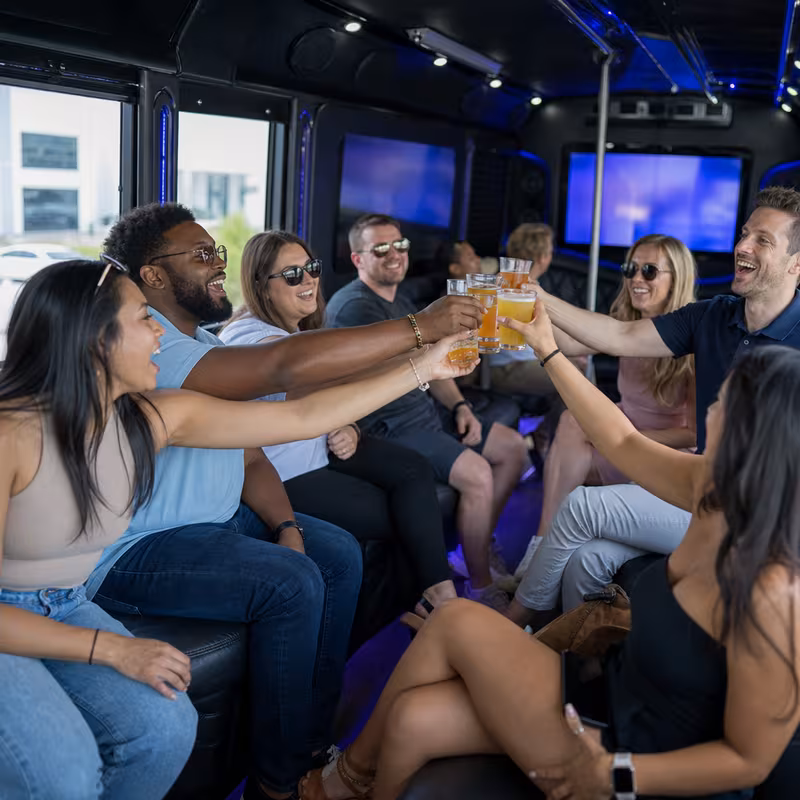 Group boarding a white charter bus for Winery & Brewery Tour Transportation transportation in Aurora